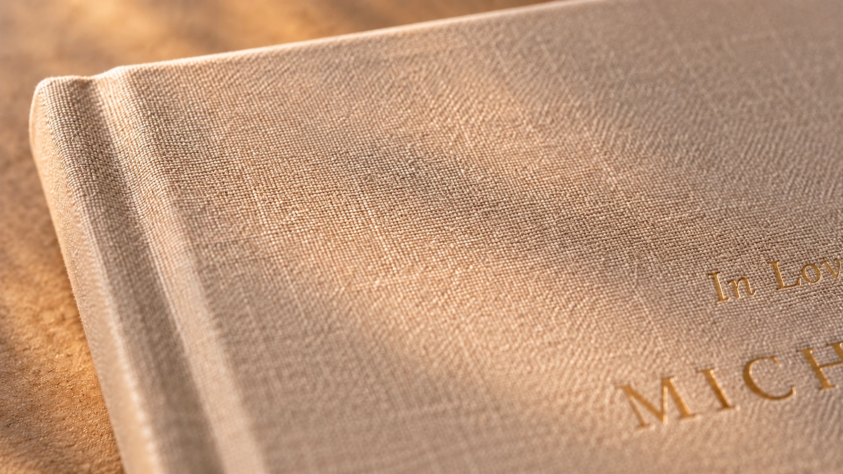 A close view of the gold foil emblem pressed into the linen cover.